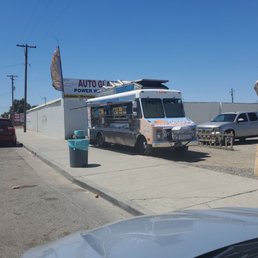 a taqueria truck parked on the side of the road