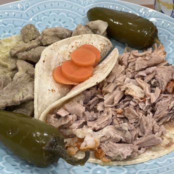 Jalisco Restaurant - Tacos on dinner plate. Pork in green sauce (L); Carnitas (R) $4.58 each taco - Mexican Near Me - Oakland, California Jalisco Restaurant - Tacos on dinner plate. Pork in green sauce (L); Carnitas (R) $4.58 each taco - Mexican Near Me - Oakland, California