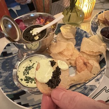 Bar Cecil - Caviar and potato chips with onion crème fraîche. It was just like old school chips and dip flavor. Yum. I'd love a Bellini option though. - Cocktail Bars Near Me - Palm Springs, California