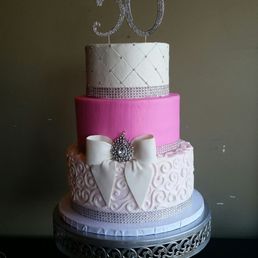 a pink and white wedding cake