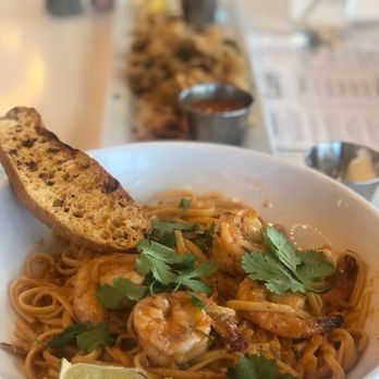 Lure Fish House - Tequila Lime Shrimp Pasta and Calamari in the background. - Seafood Near Me - Porter Ranch, California