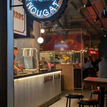 Le Central - a restaurant with a neon sign above the counter - Desserts Near Me - Montreal, Quebec
