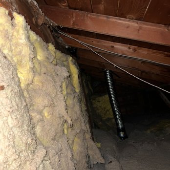 Attic Doctor - Before photo of old insulation (musty blown-in stuff on the floor) - Insulation Installation Near Me