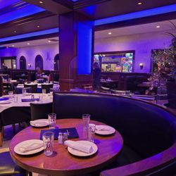 Boston Fish Market - Elegant dining room with semi-circular booths and classic tables