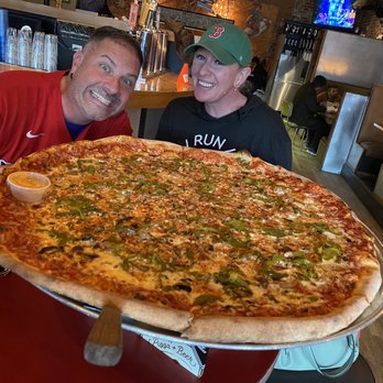 Atomic Cowboy - Colfax - Pizza comes in one size, big!  Mushrooms, Italian sausage and roasted green peppers this time. - Cocktail Bars Near Me - Denver, Colorado