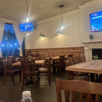 Kuzina - a dining room with a fireplace and televisions - Mediterranean Near Me - Staten Island, New York Kuzina - a dining room with a fireplace and televisions - Mediterranean Near Me - Staten Island, New York