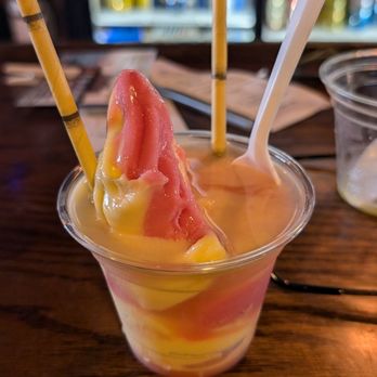 Tipsy Tiki bar - Dole Whip (pineapple/strawberry swirl) with rum. - Tiki Bars Near Me - Madeira Beach, Florida
