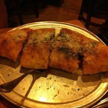 OneSpeed - Calzone cut into 4, it was a disappointed big but kind if soggy inside.  3stars would get it again looks better than it taste. - Italian Near Me - Sacramento, California