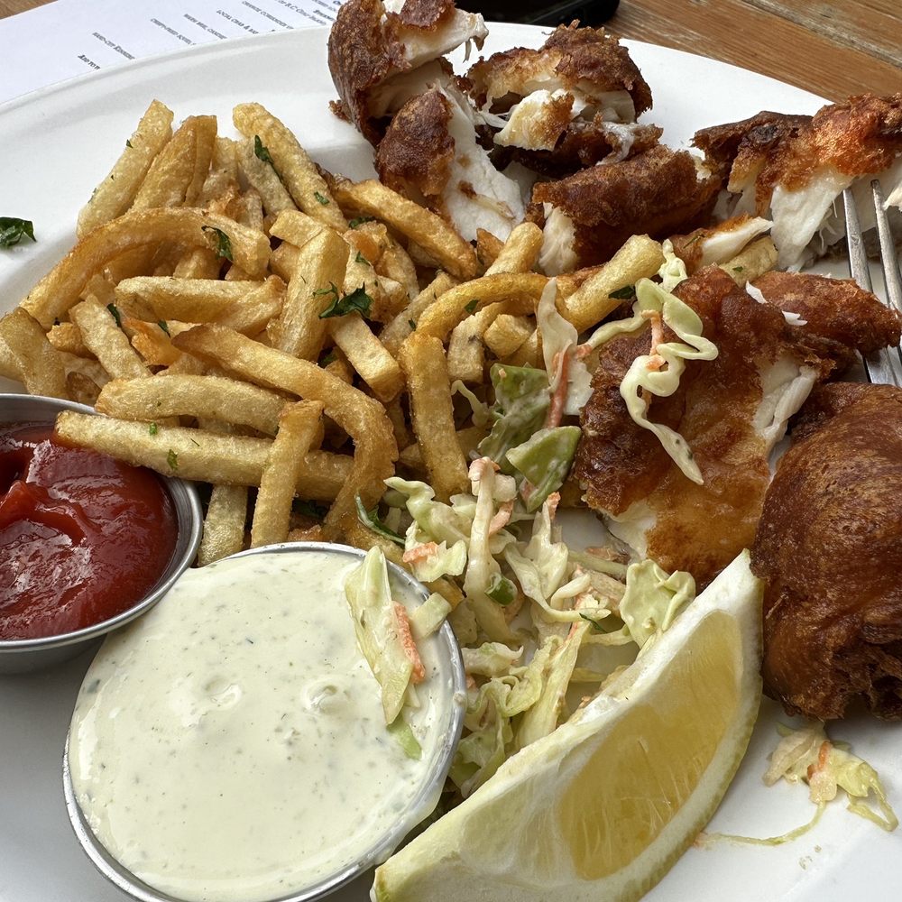Fish and chips. (Took after cut up fish). 7 out of 10. Breaded perfect amount. Fries great tasting with cilantro and perfect crispiness.