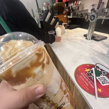 Starbucks - a hand holding a cup of iced coffee - Coffee & Tea Near Me - Mesquite, Texas Starbucks - a hand holding a cup of iced coffee - Coffee & Tea Near Me - Mesquite, Texas