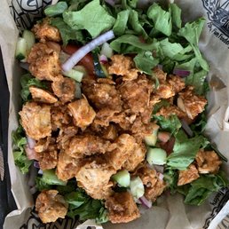 Garden salad with fried chicken tossed in hot garlic parm