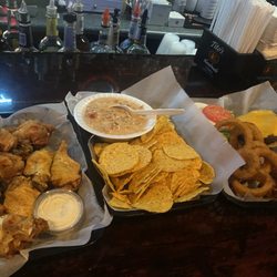 Ellie's Crow Bar & Grill - Lemon Pepper Wings, Chips and Queso, and Cheeseburger w/Onion rings.