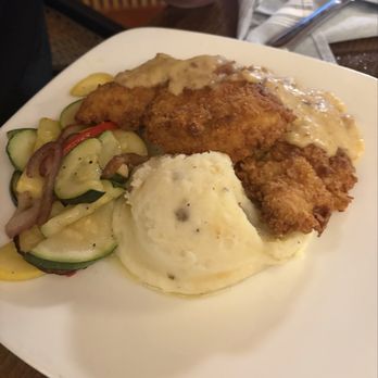 Henry's - Fried pork chops and gravy with mashed potatoes and the seasonal veggies - New American Near Me - Wilmington, North Carolina