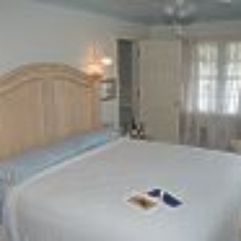 Grapefull Sisters Vineyard - a bedroom with a bed, dresser, and a couch - Wineries Near Me - Tabor City, North Carolina Grapefull Sisters Vineyard - a bedroom with a bed, dresser, and a couch - Wineries Near Me - Tabor City, North Carolina
