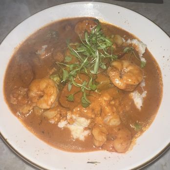 Red Rooster Overtown - Shrimp and grits with sausage in a sauce - Cocktail Bars Near Me - Miami, Florida Red Rooster Overtown - Shrimp and grits with sausage in a sauce - Cocktail Bars Near Me - Miami, Florida