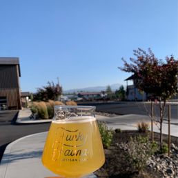 a hand holding a glass of beer