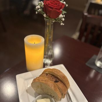 Jeff's Inviting Food and Spirits - a glass of orange juice and a piece of bread - American Near Me - Orange, California Jeff's Inviting Food and Spirits - a glass of orange juice and a piece of bread - American Near Me - Orange, California