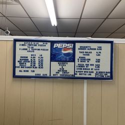 Marco's Pizza & Sub - Menu on wall behind cash register - they do take credit/debit cards