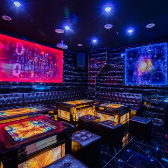 ET KTV - a brightly lit room with black leather couches and tables - Karaoke Near Me - Thornhill, Ontario