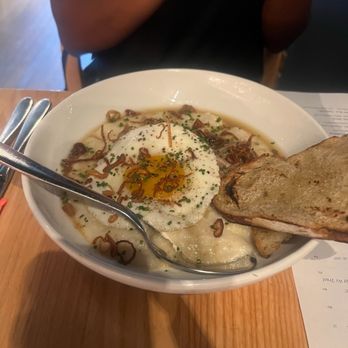 Little Fox - Pork & Grits   24 Newman Farm pork, white cheddar grits, sunny side up egg, crispy shallot - New American Near Me - Saint Louis, Missouri