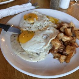 BISCUITS AND GRAVY Cheddar chive biscuits, topped with mushroom & sausage gravy, potatoes, & sunny side up egg. BISCUITS AND GRAVY Cheddar chive biscuits, topped with mushroom & sausage gravy, potatoes, & sunny side up egg.