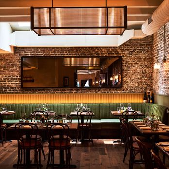 Felice on Hudson - An inviting restaurant interior featuring exposed brick walls, a long green velvet banquette, and wooden tables... - Bars Near Me - New York, New York Felice on Hudson - An inviting restaurant interior featuring exposed brick walls, a long green velvet banquette, and wooden tables... - Bars Near Me - New York, New York