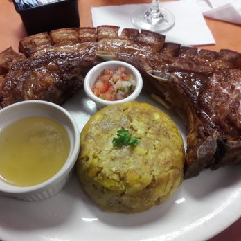 Mi Viejo San Juan - It's called Chuletas Kan Kan (Kan Kan pork chops)! And wowee!! And a side of Mofongo (Fried smashed plantain) with chick broth. - Puerto Rican Near Me - Orlando, Florida Mi Viejo San Juan - It's called Chuletas Kan Kan (Kan Kan pork chops)! And wowee!! And a side of Mofongo (Fried smashed plantain) with chick broth. - Puerto Rican Near Me - Orlando, Florida