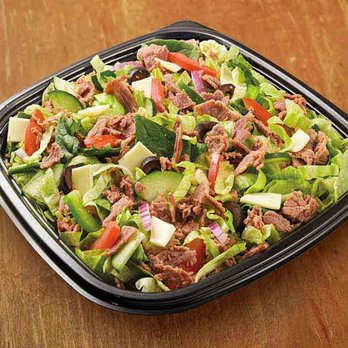 Subway - a salad in a plastic container on a wooden table - Sandwiches Near Me - Chicago, Illinois Subway - a salad in a plastic container on a wooden table - Sandwiches Near Me - Chicago, Illinois