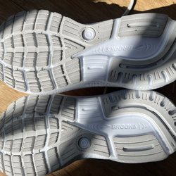 Road Runner Sports - Dirty white soles with a rock.