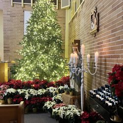 St Nicholas Catholic Church - Poinsettias decorate the church everywhere. And the tree was a beautiful lit sight during the Christmas Eve candlelight ceremony.