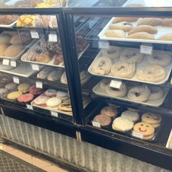 El Paso's Bakery - A glass bakery display case showcases an assortment of cookies, pastries, and baked treats, organized on multiple trays. - Bakeries Near Me - El Paso, Texas
