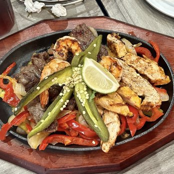 Mexcal Cantina Pacifico - Beef and chicken fajitas for two. That pepper on top is grilled and it is so very hot. - Mexican Near Me - Houston, Texas Mexcal Cantina Pacifico - Beef and chicken fajitas for two. That pepper on top is grilled and it is so very hot. - Mexican Near Me - Houston, Texas