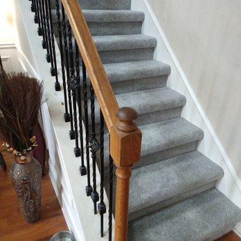 Better Home Flooring - Carpeted steps with rod iron rails installed - Carpet Installation Near Me