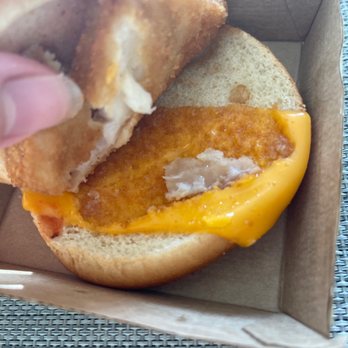 McDonald's - a hand holding a half eaten sandwich - Fast Food Near Me - Pittsburg, California