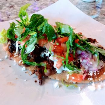 La Mejikana - Carne Asada Huarache - Garnished with Lettuce, Tomato, Chihuahua Cheese, and Sour Cream - Mexican Near Me - Chicago, Illinois La Mejikana - Carne Asada Huarache - Garnished with Lettuce, Tomato, Chihuahua Cheese, and Sour Cream - Mexican Near Me - Chicago, Illinois