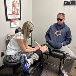 Zozzaro Chiropractic & Rehab - A man getting laser therapy on his knee at Zozzaro Chiropractic and Rehab in Normal IL