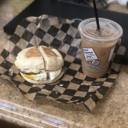 Sausage egg tomato and cheese on an English with Swiss chocolate iced coffee Sausage egg tomato and cheese on an English with Swiss chocolate iced coffee