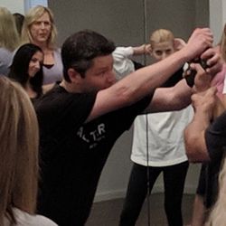 Master Ryan demonstrating to his students one way to successfully disarm a gun!