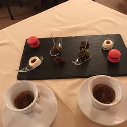 Osteria dello Strecciolo - Cafes with mini desserts from L to R Macaroon, panna cotta with caramel, chocolate with pina colada inside, dark chocolate with anise