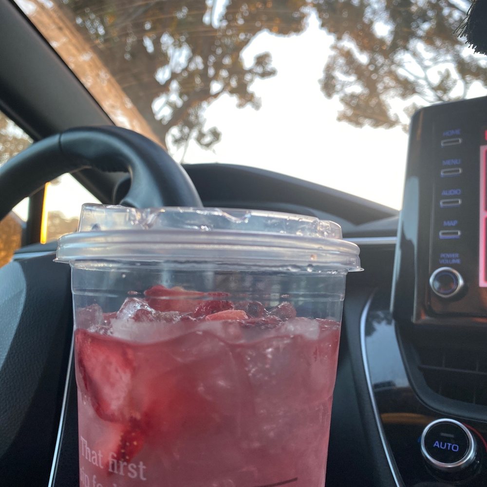 a drink in a plastic cup in a car a drink in a plastic cup in a car