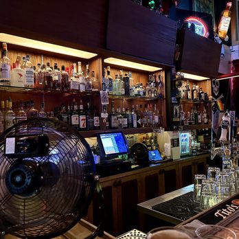 The Meyer - a man sitting at a bar with a fan - Bars Near Me - Seattle, Washington