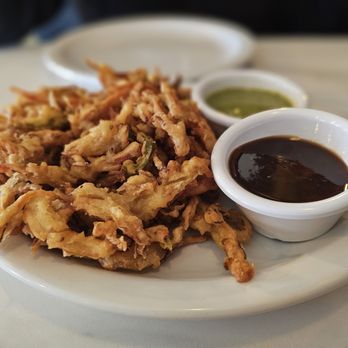 Spice Junction - Mixed vegetable pakora with two sauces: mint chutney and tamarind. - Indian Near Me - Baton Rouge, Louisiana Spice Junction - Mixed vegetable pakora with two sauces: mint chutney and tamarind. - Indian Near Me - Baton Rouge, Louisiana