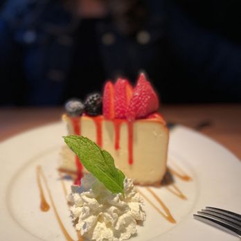 Larsen's Grill - a slice of cheesecake with whipped cream and berries - Steakhouses Near Me - Oxnard, California