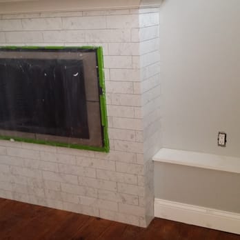 Wayne's Construction - a white brick fireplace in a living room - General Contractors Near Me Wayne's Construction - a white brick fireplace in a living room - General Contractors Near Me