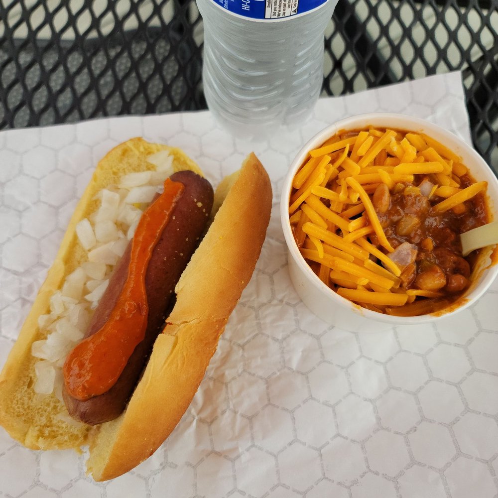 Naked Dockside Dogs dog with ghost pepper mustard and onions and a bowl of steakhouse chili