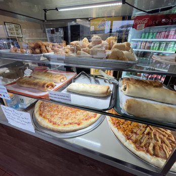 Verona Pizza - a variety of pizzas in a display case - Pizza Near Me - Bronx, New York