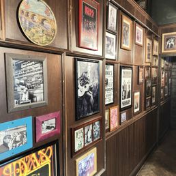 a wall full of framed pictures