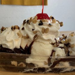 Little Rox's Ice Cream Shop - Brownie Delight:    Heated brownie topped with  ice cream, hot fudge, whipped topping, nuts and a cherry on top to finish it off.