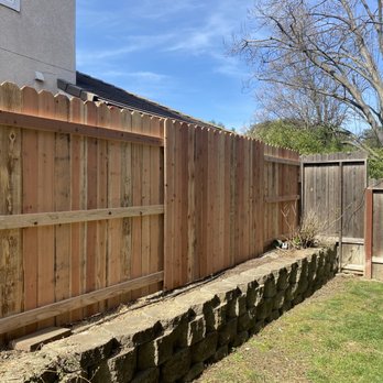 JR Landscaping - a wooden fence with a raised planter - Landscaping Near Me JR Landscaping - a wooden fence with a raised planter - Landscaping Near Me