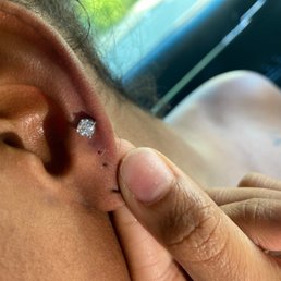 Piercing clearly close together . She had to remove it hence the blood spot . Piercing clearly close together . She had to remove it hence the blood spot .
